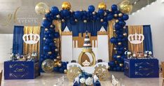 a blue and gold birthday party with balloons, table settings and decorations on the walls