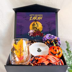 a halloween gift box filled with treats and decorations