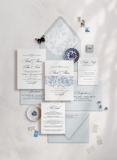 the wedding stationery is laid out on top of each other, including an envelope