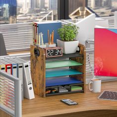 an office desk with a clock, laptop and other office supplies on top of it