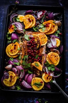 salmon with pomegranate, oranges and onions on a sheet of food