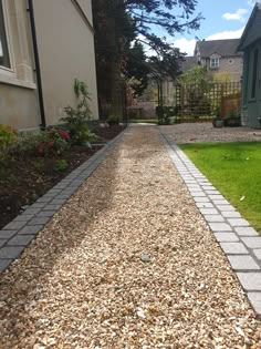 a graveled path in front of a house