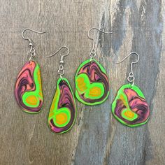 Lightweight neon green, pink, orange and black earrings that glow in UV light - perfect for dancing at a rave or party! This is a one-off design, so these are truly unique earrings! Earring hooks are made from stainless steel.  All packaging is recyclable and/or recycled. Neon Yellow Drop Earrings As A Gift, Handmade Rave Jewelry For Party, Adjustable Funky Earrings For Festivals, Multicolor Rave Jewelry For Festival, Funky Pink Jewelry For Party, Trendy Neon Jewelry For Party, Multicolor Rave Jewelry For Party, Vibrant Green Dangle Jewelry, Multicolor Rave Festival Jewelry