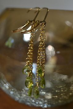 "Each of these Birthstone earrings display Three (3) beautiful Peridot Tear drop briolettes on a variegated length chain section for added flow and sparkle. They can be crafted in: 14k Gold Fill (displayed), Sterling Silver, or 14k Rose Gold Fill. The gemstones used are natural Olivine (Peridot). Peridot is the birthstone for the month of August and serves as the 16th Precious Stone Anniversary Gift. As a healing stone, Peridot is a stone associated with Growth and Rebirth and belongs to the Hea Gold Peridot Earrings Fine Jewelry, Yellow Gold Peridot Teardrop Jewelry, Yellow Gold Peridot Dangle Earrings, Green Briolette Earrings For Anniversary, Formal Peridot Drop Earrings, Gold Peridot Gemstone Earrings, Elegant Pierced Peridot Jewelry, Gold Teardrop Peridot Earrings, Gold Peridot Earrings For May Birthstone