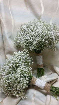 two bouquets of baby's breath on a white cloth