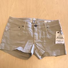 Mid-Rise Cotton/Lycra Tan Shorts! Mid-rise Beige Shorts For Summer, Casual Mid-rise Beige Shorts, Beige Mid-rise Casual Shorts, Beige Athletic Shorts With Built-in Shorts For Summer, Mid-rise Beige Summer Shorts, Beige Cotton Jean Shorts With Pockets, Fitted Brown Cotton Shorts, Beige Cotton Jean Shorts, Tan Shorts