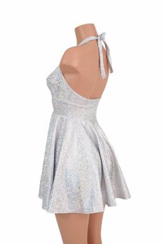 "This item is made to order, please read all the way through the listing before purchasing! This flowy dress is made of silver on white shattered glass holographic spandex. The halter top is darted and ties behind the neck, the hemline is circle cut. Length: 17\" measured from the waist to the hemline. We can create this dress from any other fabric in our shop, just ask! Womens Sizing (See below for instructions on where measurements should be taken) XXS: Bust 29\"-30\" / Waist 22\"-23\" / Hips Elegant Silver Dress For Costume Party, Disco Dress Halter, Silver Backless Dresses For Party Season, Silver Backless Dress For Party Season, White Glitter Party Dress, Silver Sleeveless Dress For Homecoming, Silver Dresses For Summer Homecoming, Holiday Silver Glitter Dress, Fitted Silver Glitter Dress