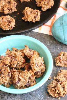 a blue bowl filled with oatmeal cookies