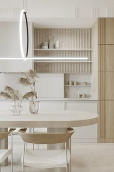 a white table and chairs in a room with wooden shelves on the wall behind it