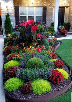 a flower garden in front of a house