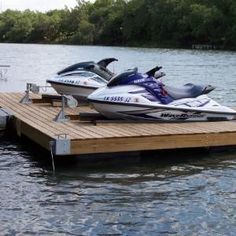 two jet skis are parked on a wooden dock