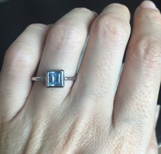 A Teeny square-shaped genuine Swiss Blue Topaz handcrafted in sterling silver, makes a great birthstone ring for those December Birthday gals or a great stackable ring or pinky/thumb/midi ring as it is small stone! Wrapped in a box ready for gift giving.(r-new-1) Blue Topaz measures 6mm *LIKE* us on Facebook http://www.facebook.com/Belesas to get 10%off coupon code, *FOLLOW* us on Twitter https://twitter.com/#!/Belesas to get more exclusive coupon codes *All item are ready to ship! Free shipping Rectangular Sapphire Birthstone Ring As Gift, Square Cut Topaz Ring Gift, Sterling Silver Rings With Rectangular Birthstone, Rectangular Blue Topaz Ring For Gift, Square Cut Topaz Ring Fine Jewelry, Blue Topaz Ring With Rectangular Stone For Gift, Sterling Silver Square Cut Topaz Ring Gift, Gift Blue Topaz Ring With Rectangular Stone, Rectangular Blue Topaz Ring Gift