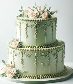 a three tiered cake with flowers on the top and sides, sitting on a platter