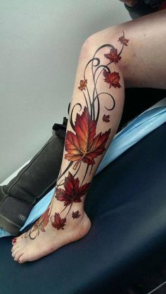 a woman's leg with leaves and vines on it