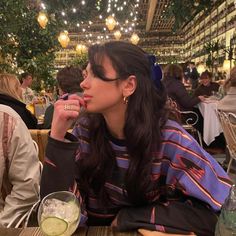 a woman sitting at a table eating food