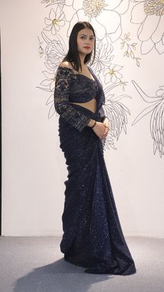 Navy Blue Lycra Net drape saree with a beautiful Net blouse with Cutdana Sequin details.The saree is the perfect choice for a party or an event where one can be chic yet graceful.-Slight variation in color is possible due to digital photography. Style: Drape Saree Fabric: Net with Laycra Work: Sequin, Cut dana Colour: Navy Blue Chest: 36 Note:- Originally Stitched in 36 but can alter for size 34 without any extra cost. Navy Blue Saree, Sequence Blouse, Indo Western Gown, Saree Petticoat, Net Blouse, Full Sleeve Blouse, Saree Jewellery, Net Blouses, Drape Saree