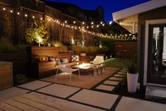 an outdoor patio with lights and seating area