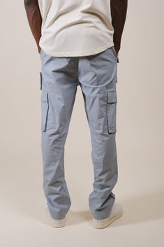 Stay up to date with all the fashion fads and bring Y2K styles back to your wardrobe with our Multi-Pocket Poplin Cargo Pant. Whether you work a blue-collar job or just love the aesthetic, a utilitarian and versatile cargo pant is a must-have staple for any streetwear-loving man. Grab a pair and unlock the limitless style options men’s cargo pants offer. Designed with one of our high-quality fabric blends to keep you comfortable with every wear, this pair of pants will keep you feeling and looki Utility Cotton Work Pants With Pockets, Tapered Leg Cotton Cargo Jeans, Urban Style Cotton Cargo Pants With Pockets, Urban Cotton Cargo Pants With Pockets, Cotton Cargo Jeans With Pockets For Workwear, Cotton Workwear Cargo Jeans, Urban Style Cotton Cargo Pants With Side Pockets, Urban Cotton Cargo Pants With Side Pockets, Urban Blue Cargo Pants For Streetwear