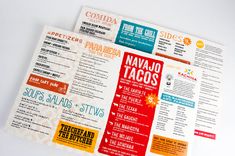 three different types of food menus on a white tablecloth with the names of various tacos