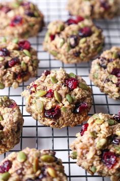 several cookies with nuts and dried cranberries on a cooling rack