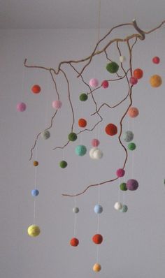 a mobile with balls hanging from it's branches