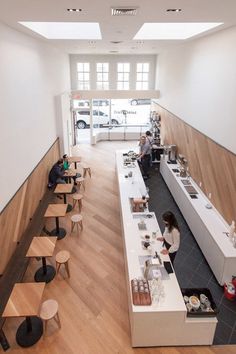 an overhead view of a restaurant with people sitting at tables and eating food on the counters