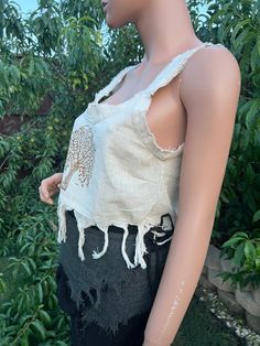 Introducing our Tree Of Life Tassel Top. This beautifully crafted crop top features a traditional Tree of Life motif, meticulously hand block printed on soft, breathable cotton. The intricate design is complemented by playful tassels, adding a touch of bohemian charm. The top has unstitched edges to make it look more natural and rugged. Perfect for warm weather, this top pairs effortlessly with high-waisted jeans, skirts, or shorts for a relaxed yet stylish look. Whether you're heading to a fest Summer Crop Top With Frayed Hem, Summer Cropped Top With Frayed Hem, Summer Cropped Crop Top With Frayed Hem, Free-spirited Cotton Top For Spring, Spring Fringe Crop Top, Beach Embroidered Cotton Crop Top, Bohemian Cotton Tops With Frayed Hem, Embroidered Summer Crop Top, Sleeveless Cotton Tops With Natural Dye