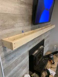 a fireplace with a flat screen tv mounted above it