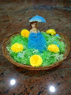 a cake in the shape of a woman with an umbrella sitting on top of grass