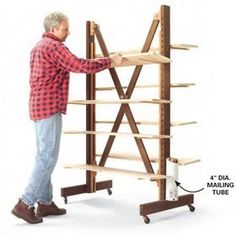 a man standing next to a tall wooden shelf