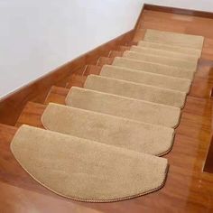 a set of beige carpeted stairs in a house