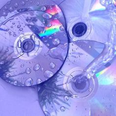 two cds with water droplets on them