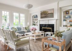 a living room filled with furniture and a fire place in front of a fireplace covered in windows