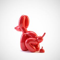 a red balloon dog laying on its back