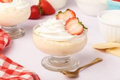 two desserts with whipped cream and strawberries in them