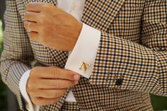 These understated Letter N Gold Cufflinks by OTAA exude a classically refined sense of style.

 

 

 

Let the glorious gold add a smart accent to your formal outfits, for a look that can take you from the boardroom to a black tie event. These cufflinks are subtly detailed and exude refinement.

 

 

 

 

Colour: Gold

Cufflink Style: 1157-CL

Details
Includes a small cylinder at the back that rotates 90 degrees to hold the cufflink in place Custom Cuff Links, Rose Gold Cufflinks, Custom Cufflinks, Personalized Cufflinks, Gold Cufflinks, Gold Letter, Letter N, Formal Outfits, Letter G