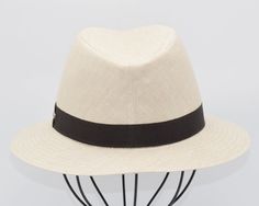 Introducing our Linen Indiana Style Hat, a timeless accessory blending classic style with modern flair. Crafted from premium linen, this hat offers lightweight comfort and breathability. Inspired by the iconic Indiana model, it features a versatile design suitable for various occasions. Whether exploring the outdoors or strolling through the city streets, this hat adds a touch of sophistication to any ensemble. Elevate your look with our Linen Indiana Style Hat, the epitome of effortless eleganc Cream Panama Hat With Short Brim For Travel, Cream Panama Hat With Curved Brim For Travel, Classic Cream Panama Hat For Travel, Classic White Panama Hat For Travel, Classic Cream Fedora For The Beach, Classic Cream Fedora For Beach, Classic Lightweight Adjustable Hat, Classic Adjustable Lightweight Hat, Classic Cream Sun Hat For Travel