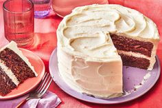 a cake with white frosting sitting on top of a purple plate