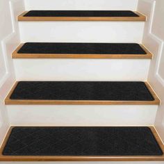 black carpeted stairs leading up to white walls