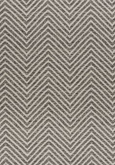 a gray and white rug with chevrons on it