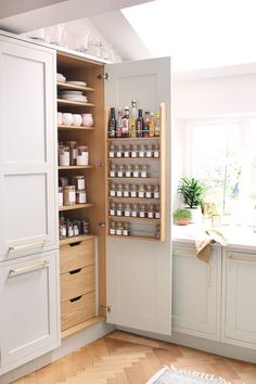 an open cabinet in the corner of a kitchen