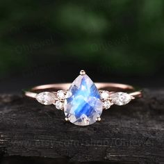 "This is a 1.3 carat natural moonstone engagement ring in solid gold,about 6X8mm pear cut. The accent stones are round 1.5mm and marquise 2x4mm moissanites. It can be made in any ring size. However please contact me to custom make it to a special big or small size. It can be made in white gold,rose gold or yellow gold with 14k or 18k. However for some people who are nickel allergic,I can also make it to 925 sterling silver to make you can wear it. The ring is handmade,very high quality! 30 days Luxury Solitaire Moonstone Ring For Anniversary, Solitaire Pear-shaped Promise Ring Jewelry, Gift Jewelry With Pear-shaped Rose Cut Diamonds, Elegant Pear-shaped Moonstone Ring, Elegant Teardrop Moonstone Ring, Pear-shaped Solitaire Promise Ring, White Gold Pear-shaped Promise Jewelry, Pear-shaped Solitaire Jewelry For Promise, Pear-shaped Solitaire Promise Jewelry