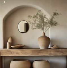 vases and mirrors on a shelf in a room