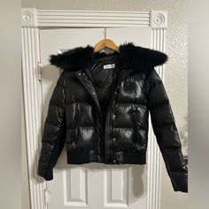 Coach Puffer Jacket With Shearling Like New Size 4. Still Has The Plastic On The Zipper. % Polyester Lining: 100% Polyester Zip And Snap Button Closures Zip Pockets Removable Shearling Collar Length: 24" Dry Clean Style No. C0347 Luxury Outerwear With Faux Fur Trim And Down Material, Black Fur Coat With Padded Collar, Black Fur Coat With Padded Collar For Fall, Designer Black Winter Outerwear, Black Puffer Jacket With Faux Fur Trim For Winter, Designer Black Puffer Outerwear, Casual Coach Winter Outerwear, Designer Quilted Winter Outerwear, Designer Puffer Outerwear For Winter