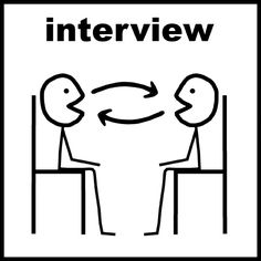 an interview sign with two people sitting at a desk and one is pointing to another person