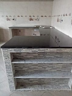 an empty kitchen with granite counter tops and tile backsplashes on the walls