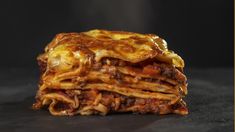 a stack of lasagna stacked on top of each other with cheese and meat