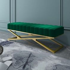 a green bench sitting on top of a marble floor next to a vase and rug