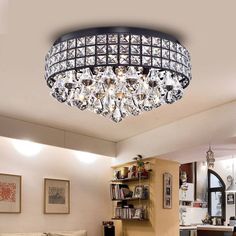 a living room filled with furniture and a crystal chandelier above the couches