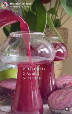 a red liquid pouring into a glass vase